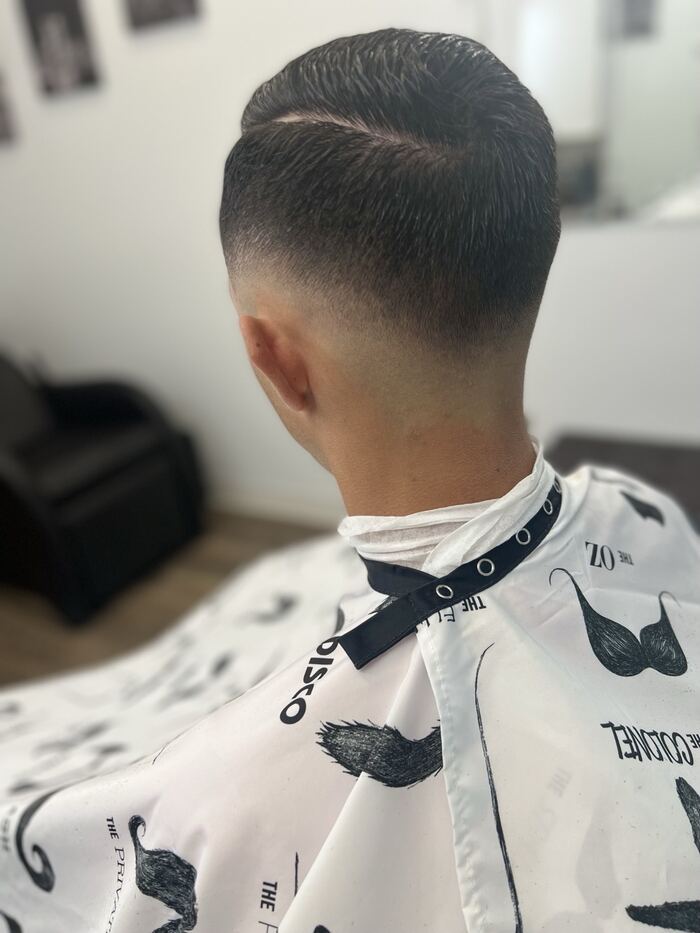 Classic side-part with a low taper fade, back view, Royal Palm Beach FL barber