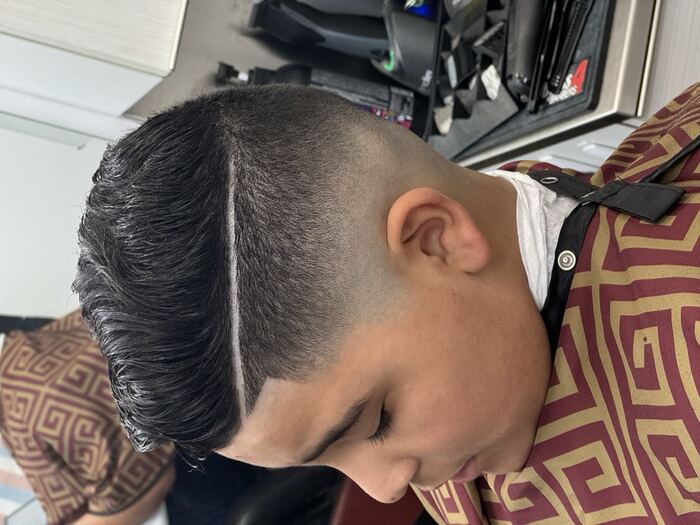 High skin fade with a textured quiff and hard part, Royal Palm Beach FL barber