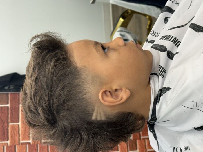 Kids' mullet with a burst fade and shaved line design at Ricky's Style Barbershop, Royal Palm Beach