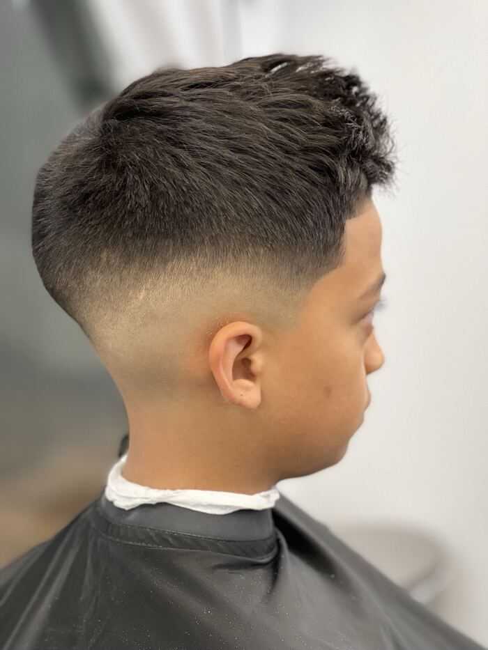 Mid drop fade with a textured spiky top, cut at Ricky's Style Barbershop, Royal Palm Beach FL