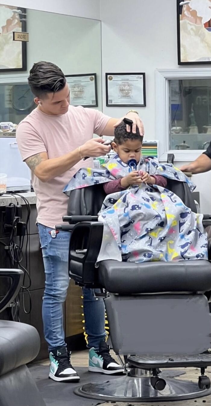 Ricky giving a young client a haircut at Ricky's Style Barbershop in Royal Palm Beach, FL